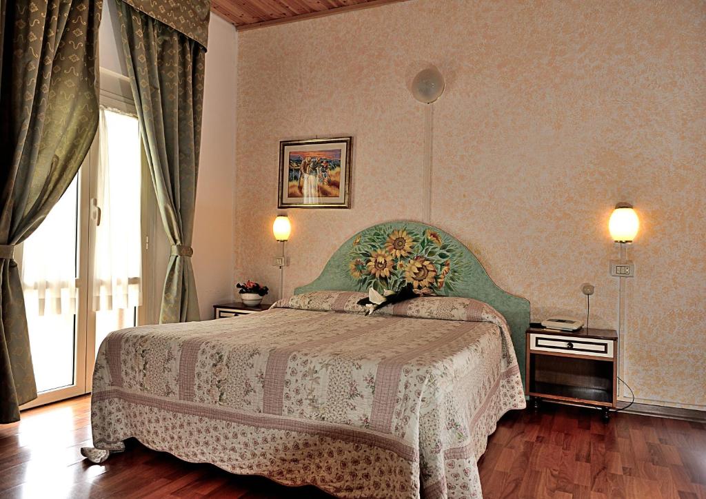 Postel nebo postele na pokoji v ubytování Albergo Ristorante Ferretti