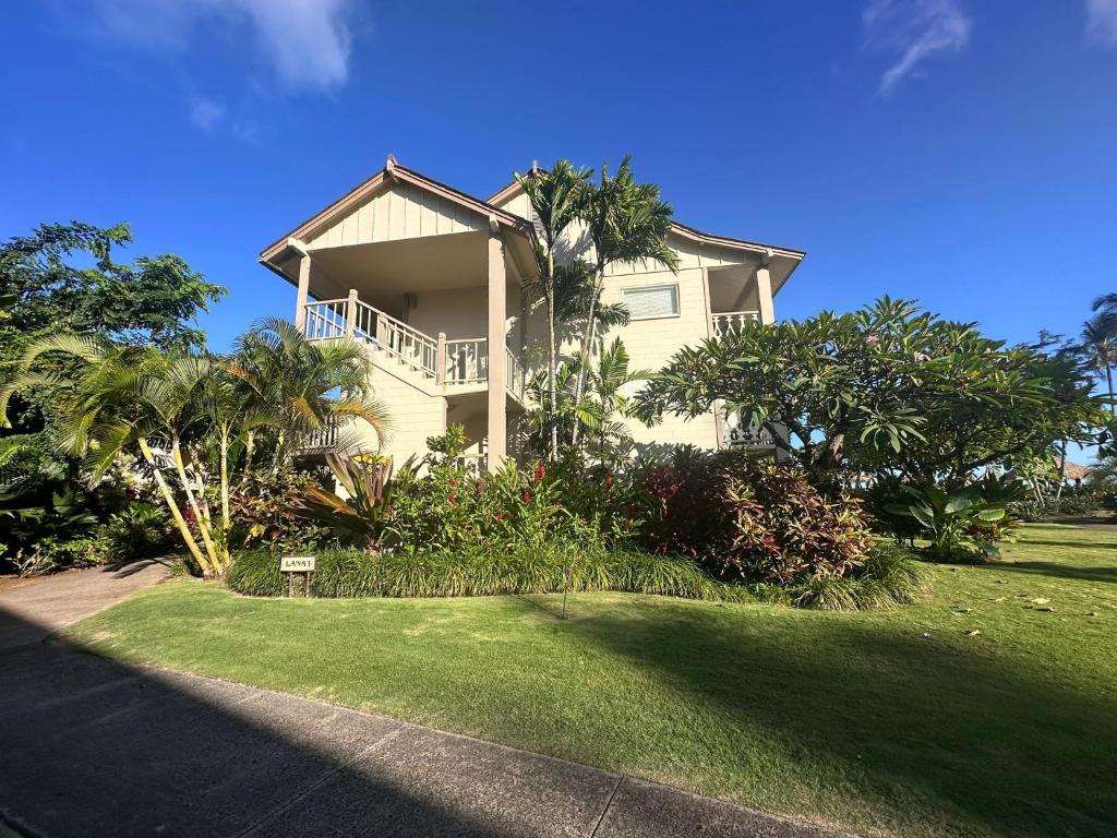 a large house with a lawn in front of it at Condominiums in kapaa in Kapaa