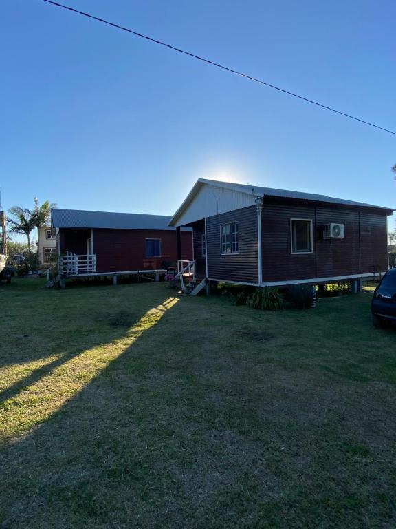 a house with a car parked in front of it at Las Cabañas del Norte in Federación