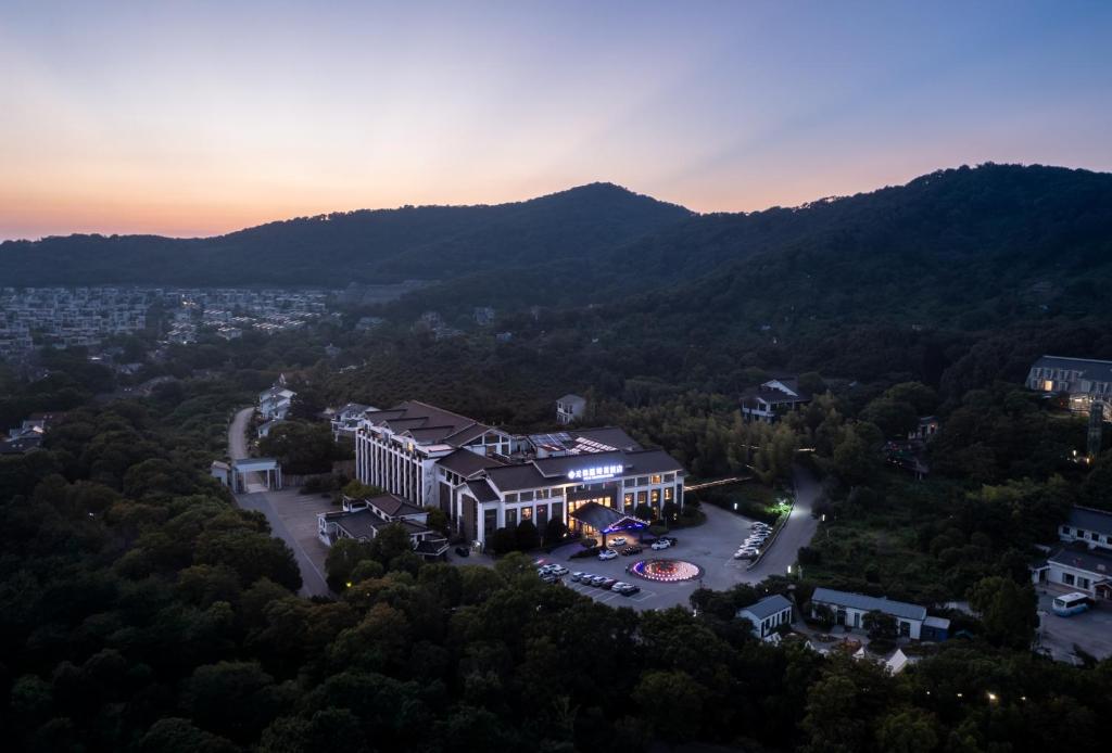 an aerial view of a building in the mountains at Wuxi Winterless Hotel in Wuxi