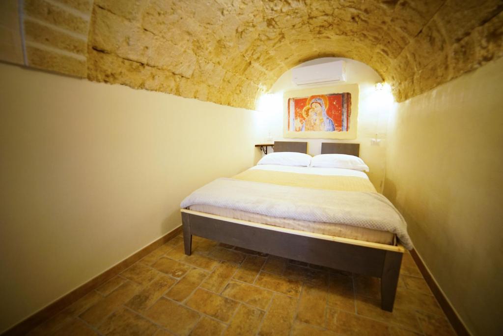 Postel nebo postele na pokoji v ubytování La Pergola ai Sassi