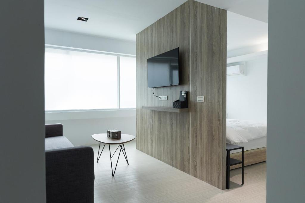 a living room with a tv and a table at 森浩文旅 in Taipei