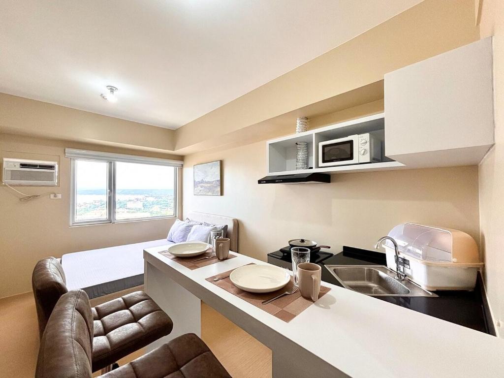 a kitchen with a sink and a counter top at Heart of CDO Scenic View in Cagayan de Oro