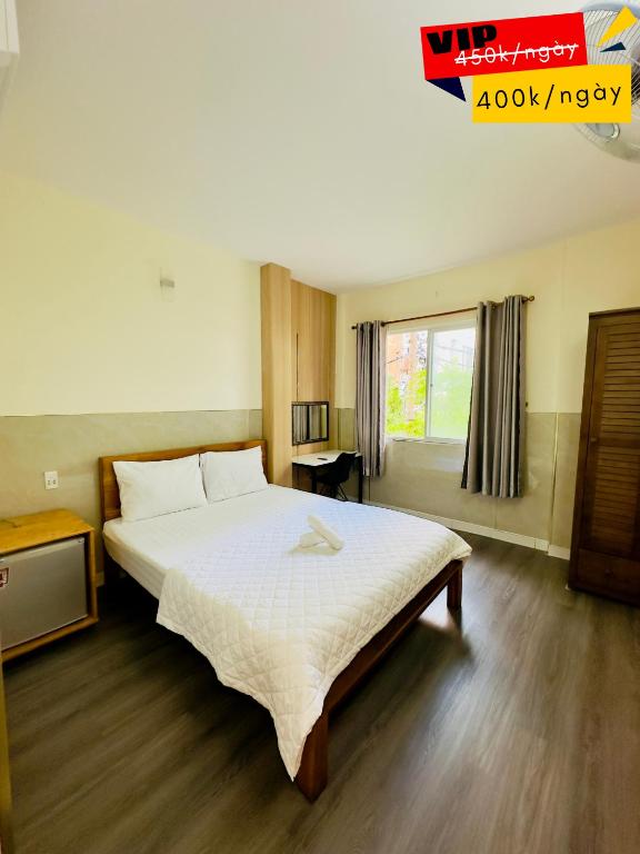 Un dormitorio con una cama grande y una ventana. en Khách sạn Thế Giới Mới - Thế Giới Mới Hotel, en Ho Chi Minh