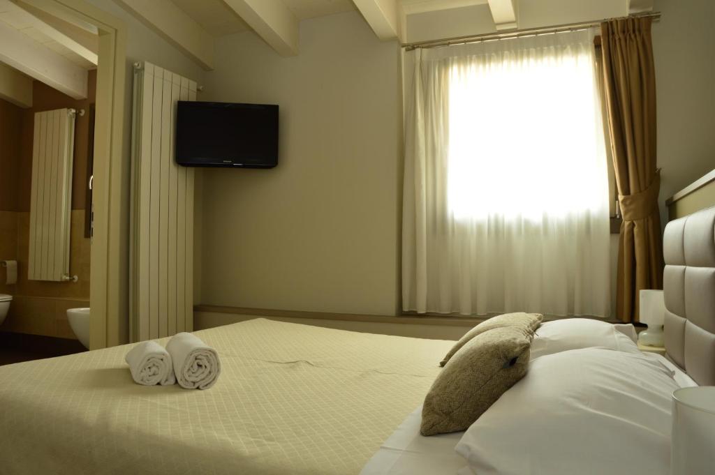 Postel nebo postele na pokoji v ubytování Locanda Blum In