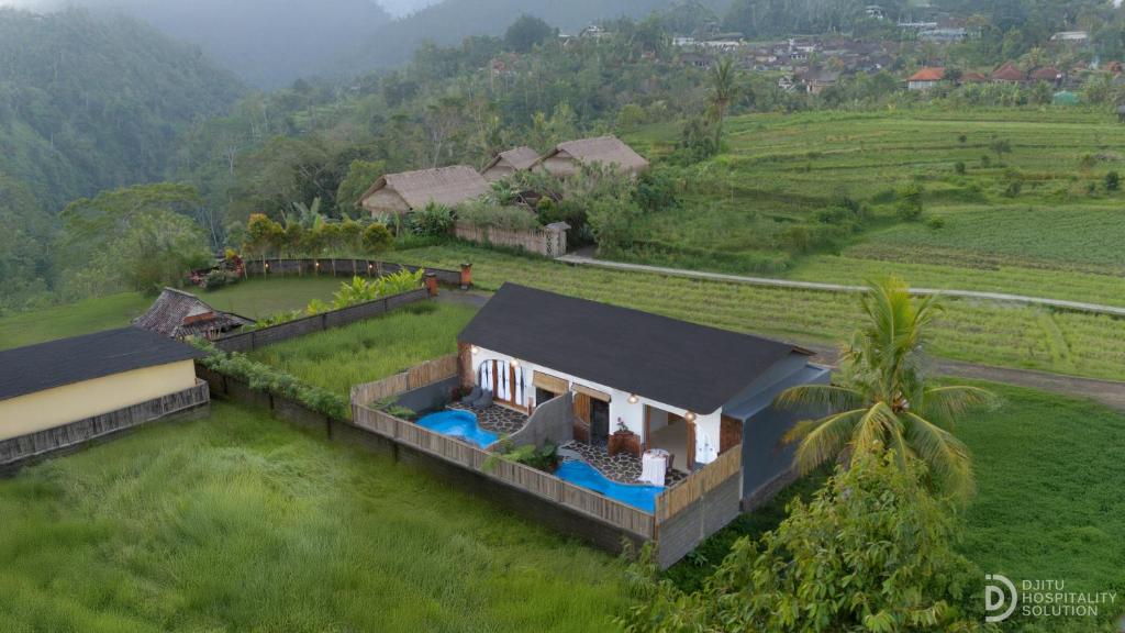 an aerial view of a house in a field at Lumina Villa Sidemen in Sidemen