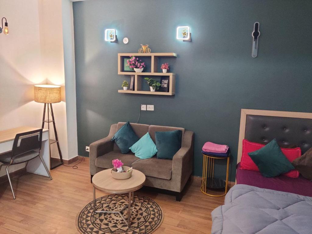 a living room with a couch and a table at Dristy homez in Noida