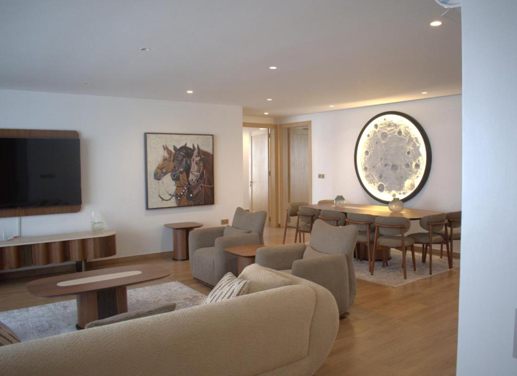 a living room with a couch and tables and a tv at Home on the hill in Kampala