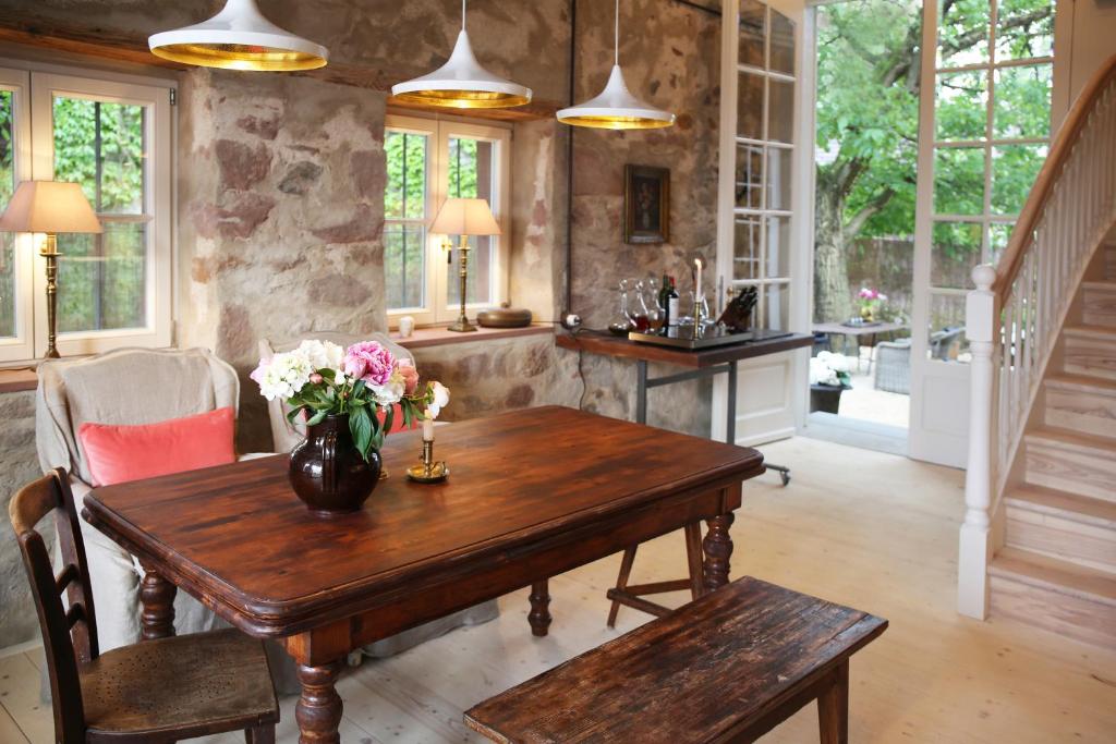 a dining room with a wooden table with flowers on it at Annas Scheune in Waldkirch