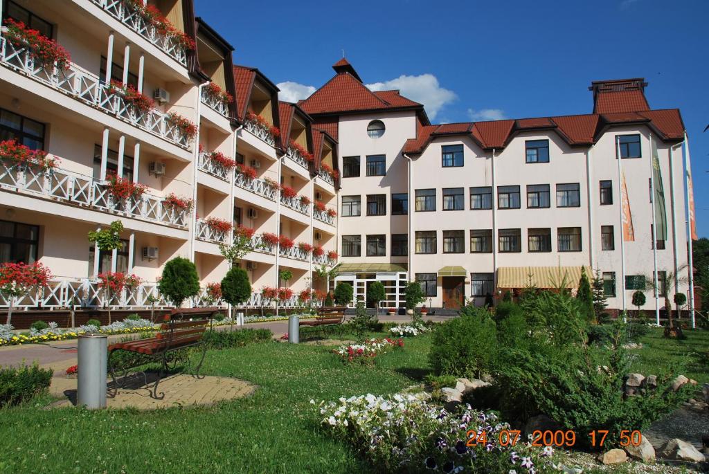 a large building with a garden in front of it at Solnichnaia Dolyna in Polyana