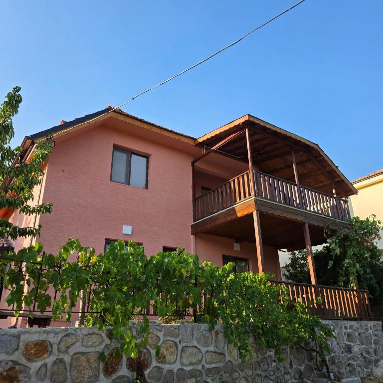 a large house with a deck on top of a wall at Uludağ Tatil Evleri & Villa Şirin in Soğukpınar