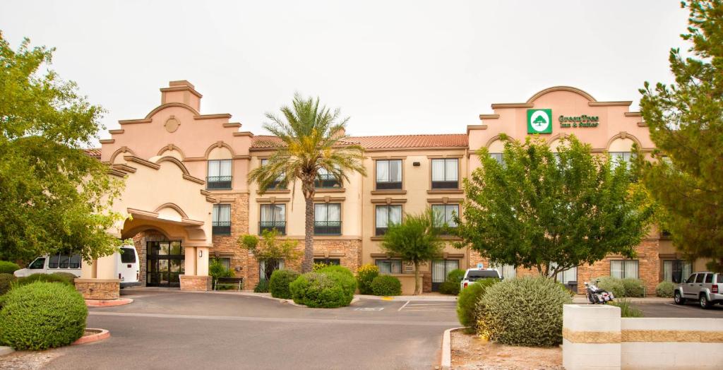 a building with a parking lot in front of it at GreenTree Inn and Suites Florence, AZ in Florence