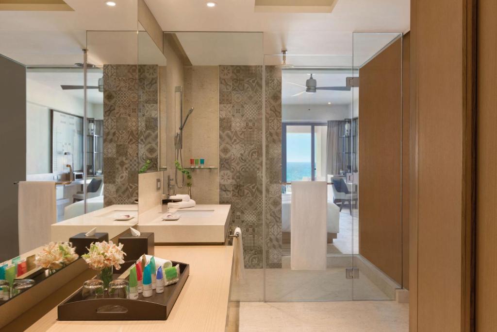 a large bathroom with a sink and a mirror at Turquoize at Hyatt Ziva Cancun - Adults Only - All Inclusive in Cancún