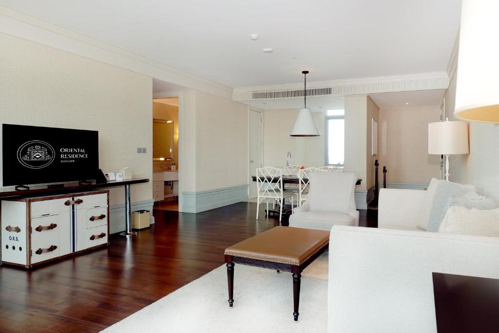 A spacious open-plan suite with a living room and dining area.