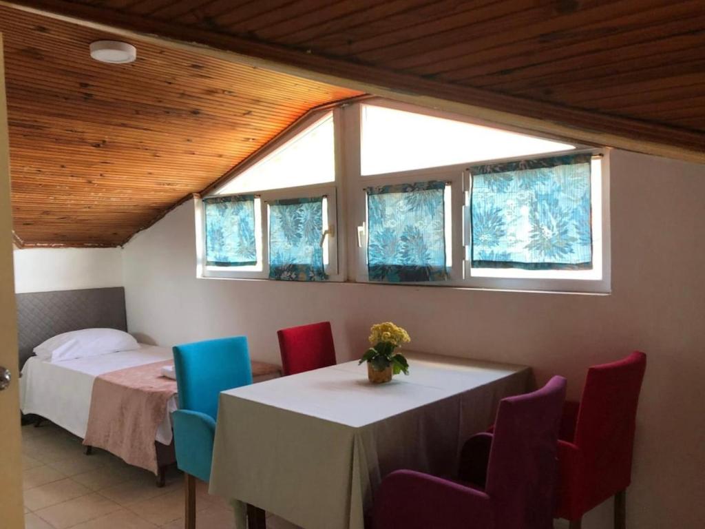 a room with a bed and a table and chairs at Deka apartments 7 in Fethiye