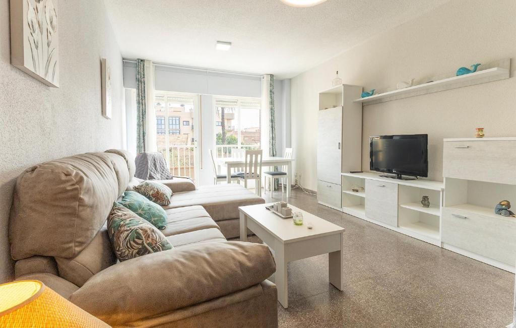 a living room with a couch and a tv at 2 Bedroom Gorgeous Home In Cartagena in Llano del Beal