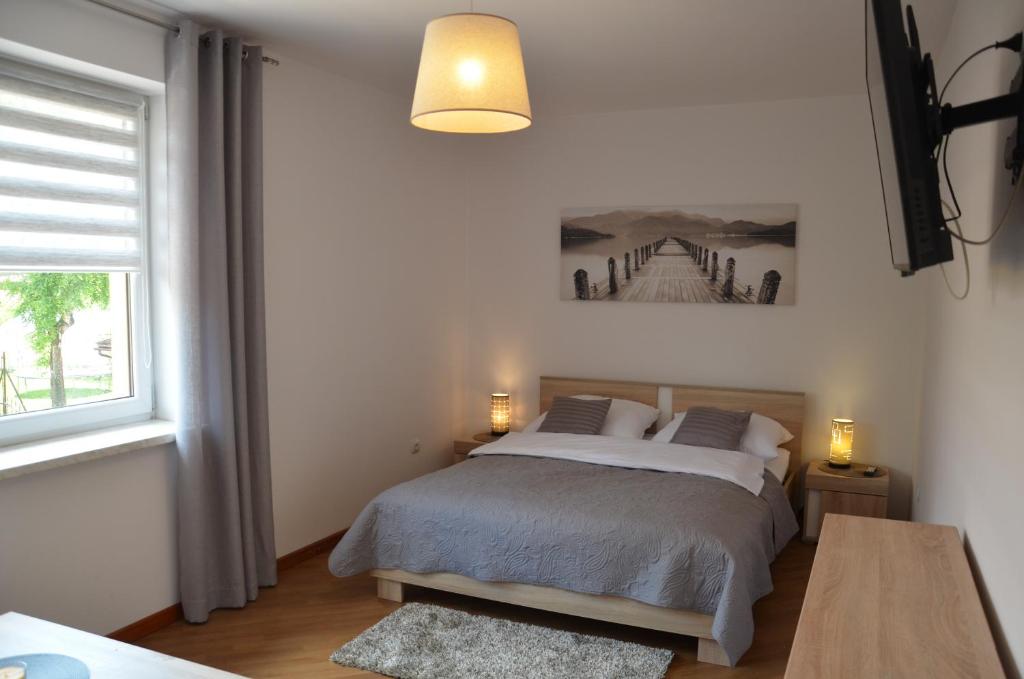 a bedroom with a bed and a window at Apartamenty Milówka Centrum in Milówka