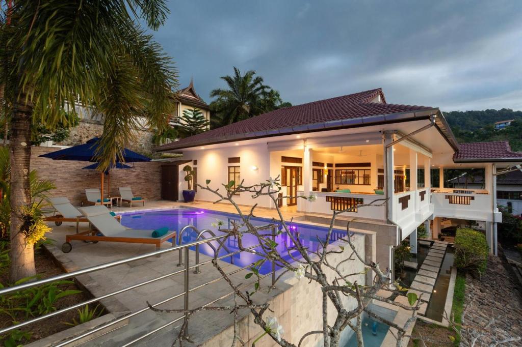 a house with a swimming pool next to a house at Baan Angelo 3 Bed Private Pool Villa, Kata Hill in Ban Kata