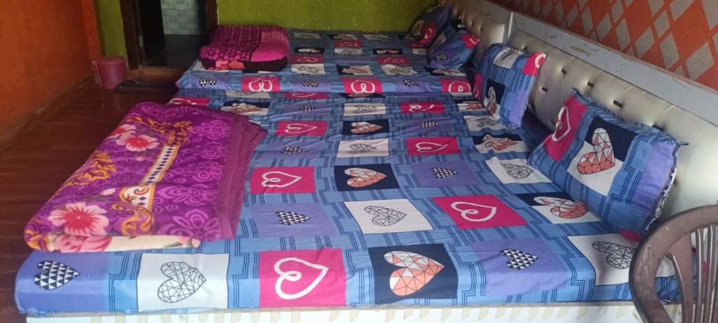 two beds with hello kitty quilts on them at Gopi Dham in Chhatikara
