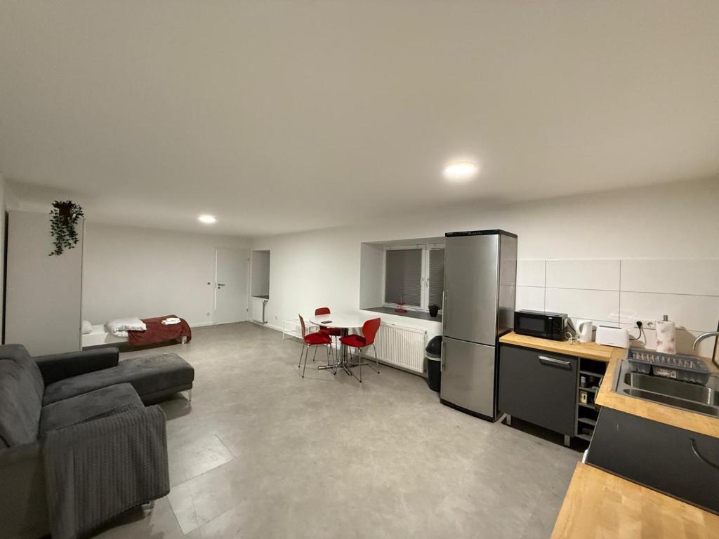 a kitchen and living room with a couch and a table at Apartment Natalie in Hagen