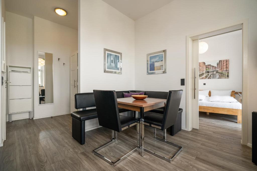 a dining room with a table and black chairs at Altstadtapartment Carli- Komfortable Ferienwohnung im Herzen von Waren in Waren