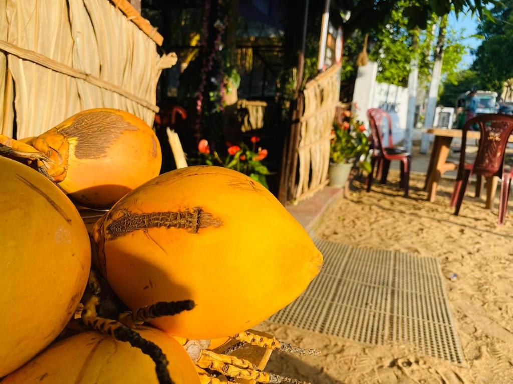 een stapel meloenen bovenop een tafel bij Saman Restaurant - Family House in Arugam Bay