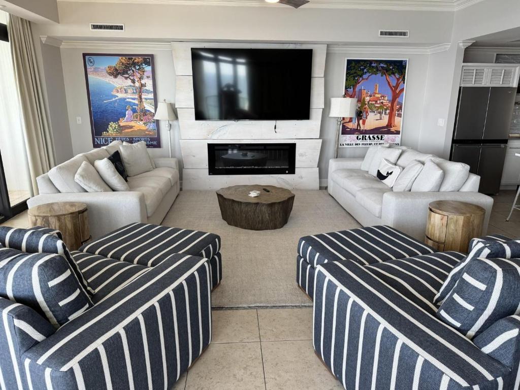 a living room with two couches and a flat screen tv at The Oasis at Orange Beach 2411 (Phoenix West II) in Orange Beach