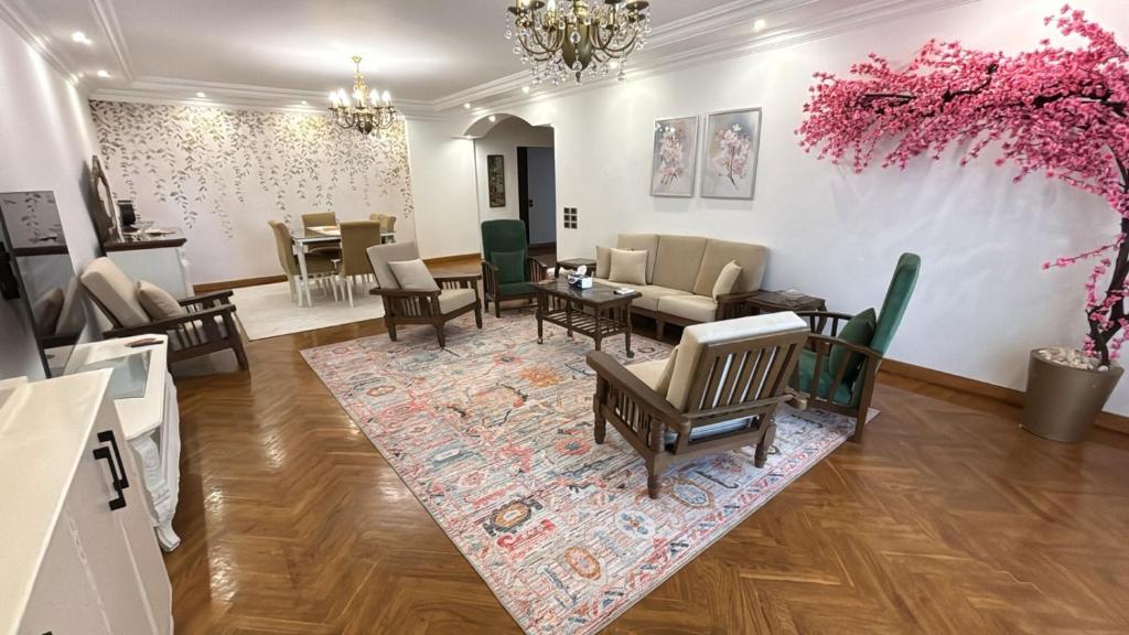 a living room with furniture and a dining room at Vintage Charm & Spacious Comfort in Zayed 2000 - only families & single travelers in Sheikh Zayed