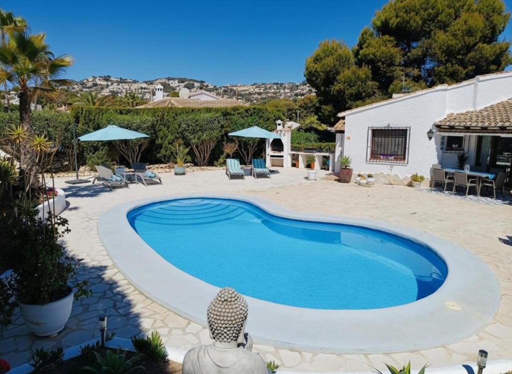 a swimming pool in the middle of a yard at Moraira Escape with Private Pool 1 Bed Sleeps 2 in Moraira