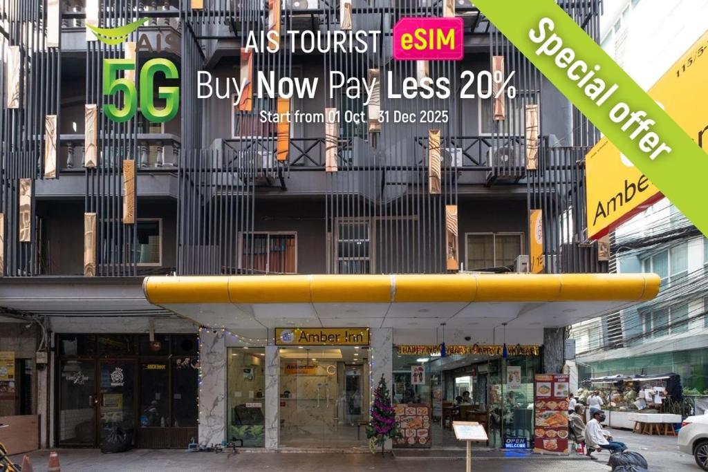 a building with a large yellow surfboard on top of it at Amber Inn in Bangkok