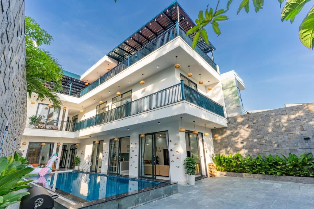 an exterior view of a house with a swimming pool at Sunny Beach Villa in Danang