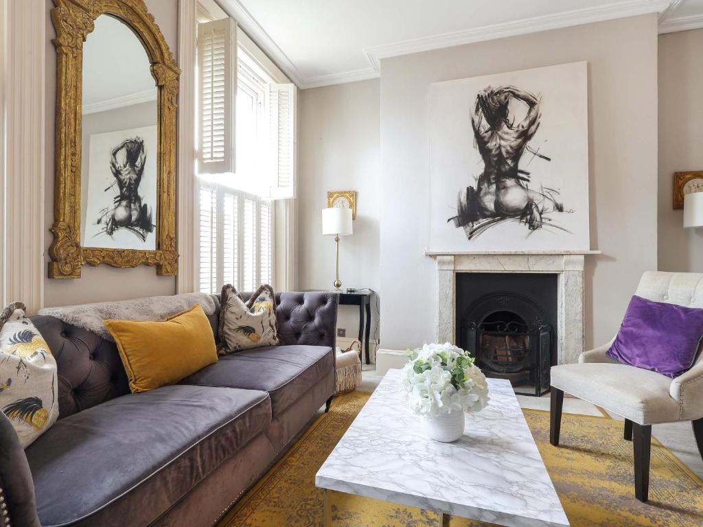 a living room with a couch and a fireplace at Prep House in Cheltenham