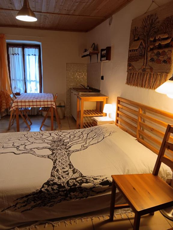 a bedroom with a bed with a tree design on it at La Casa Antica in Pont-Saint-Martin