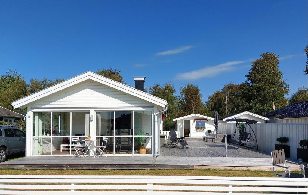 a house with a porch and a deck at 3 Bedroom Beautiful Home In Falkenberg in Stora Hansagård