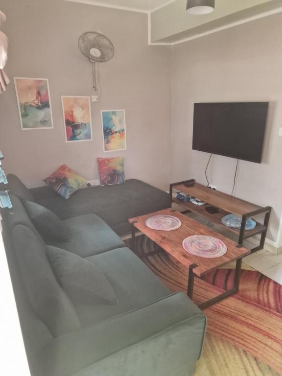 a living room with a couch and a table at Diani Beach Walk in Diani Beach