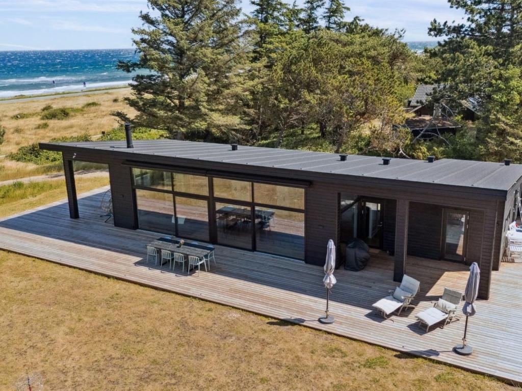 an overhead view of a house with a deck at Holiday Home Rakita - 75m from the sea by Interhome in Tjørneholm