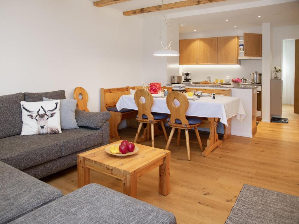a living room with a couch and a table and a kitchen at Apartment La Siala Apt-19 by Interhome in Falera