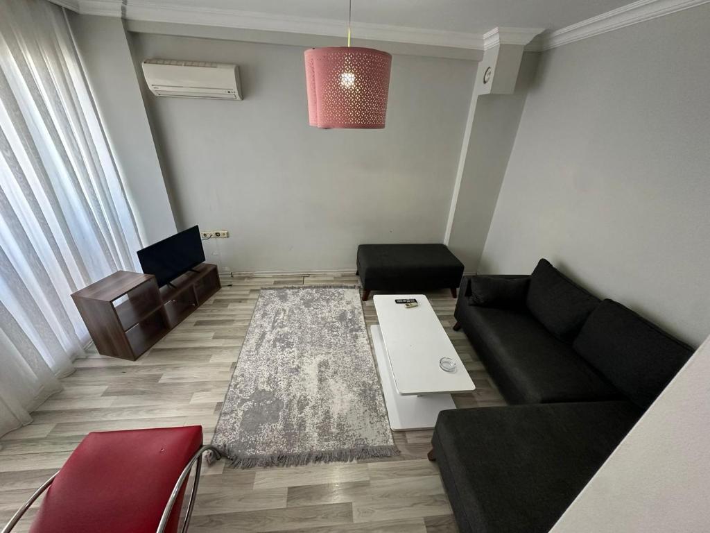 a living room with a couch and a table at İzmir homes in Buca