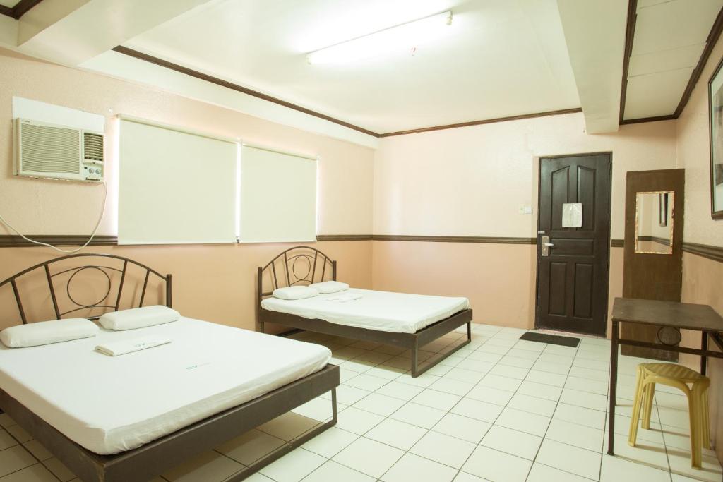 Postel nebo postele na pokoji v ubytování GV Hotel - Masbate