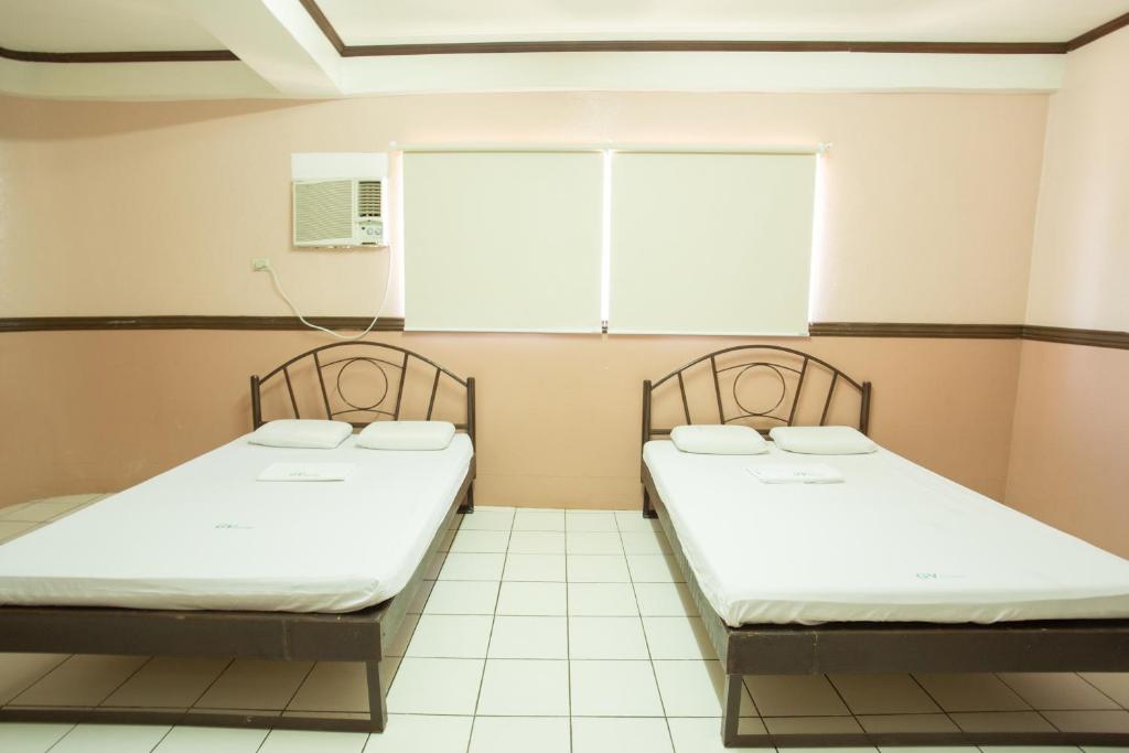 Postel nebo postele na pokoji v ubytování GV Hotel - Masbate