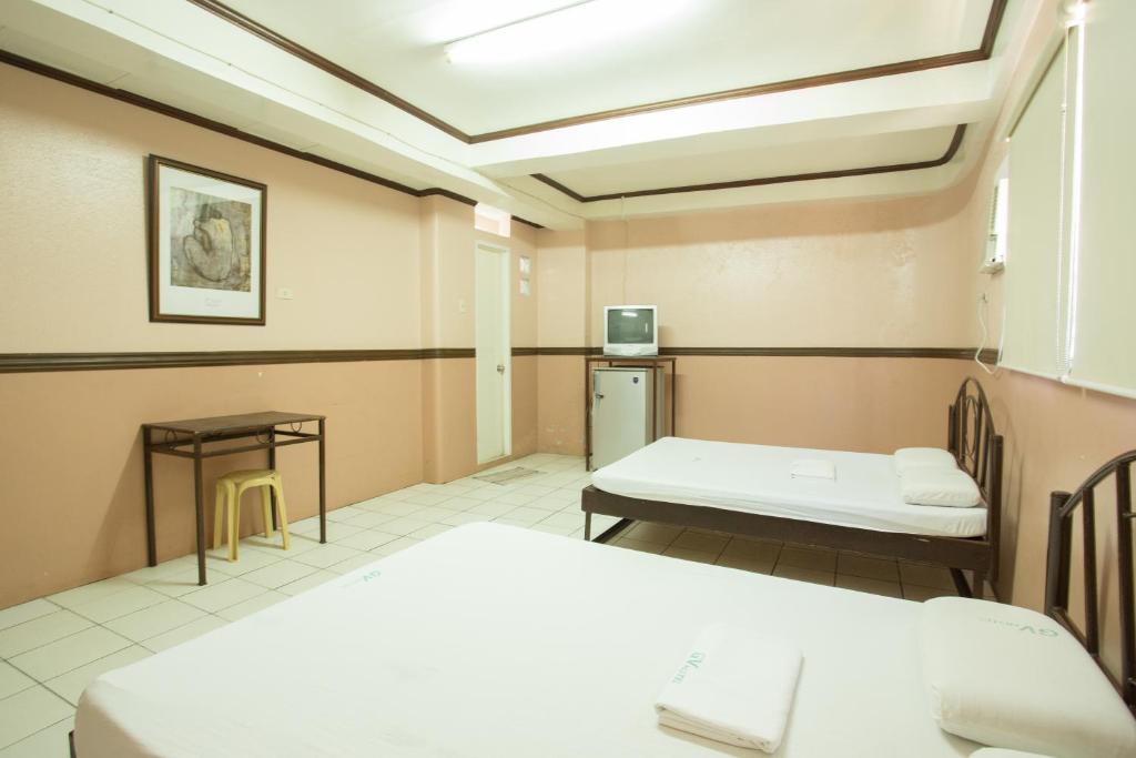 Postel nebo postele na pokoji v ubytování GV Hotel - Masbate