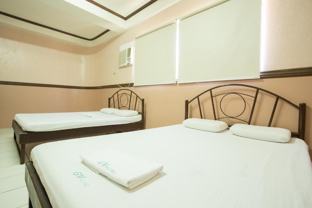 Postel nebo postele na pokoji v ubytování GV Hotel - Masbate