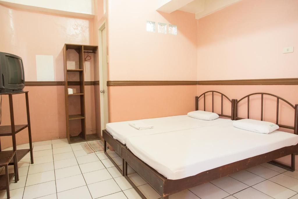Postel nebo postele na pokoji v ubytování GV Hotel - Masbate