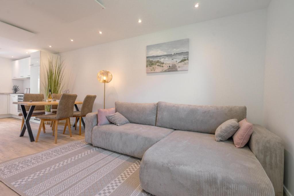 a living room with a couch and a table at Nordstrander Küstenlodge - Sternentraum in Nordstrand