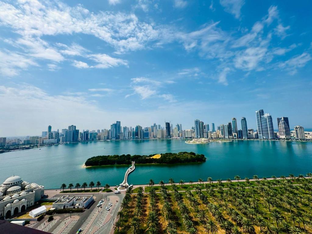a large body of water with a city in the background at Waterfront Modern loft overlooking downtown 3BR in Sharjah