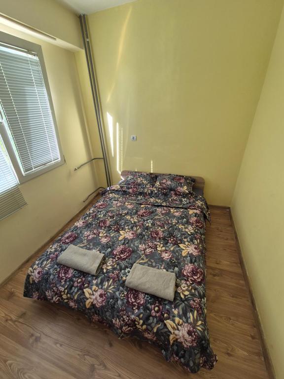 a bedroom with a bed with two pillows on it at Mladost stay apartment in Sofia