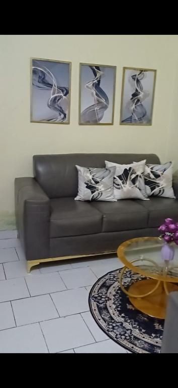 a living room with a couch and a table at Studio Meublé Yassa in Douala