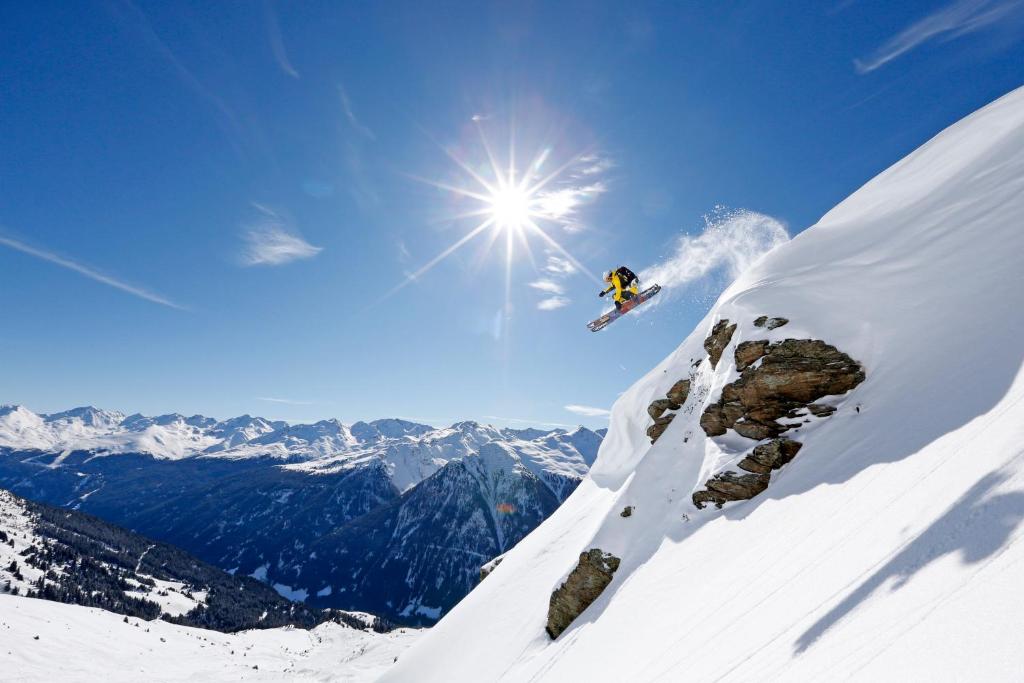 a person jumping off of a snow covered mountain at Haus Ladner in See