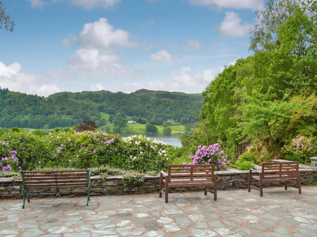 two benches in front of a view of a lake at The Old Coach House in Thornton