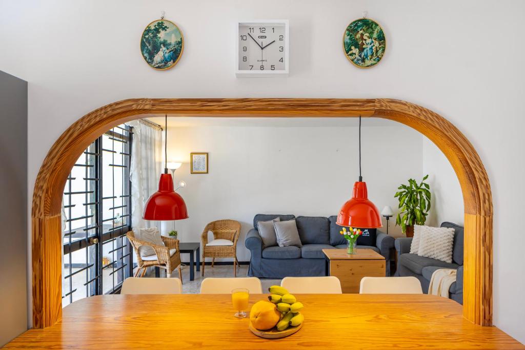 a living room with a table and a blue couch at 3BR Tauro Bungalow - Garden, Terrace, Sleeps 6 in Mogán